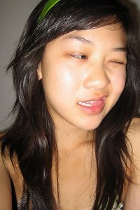 an chinese girl having an orgasm on a sofa